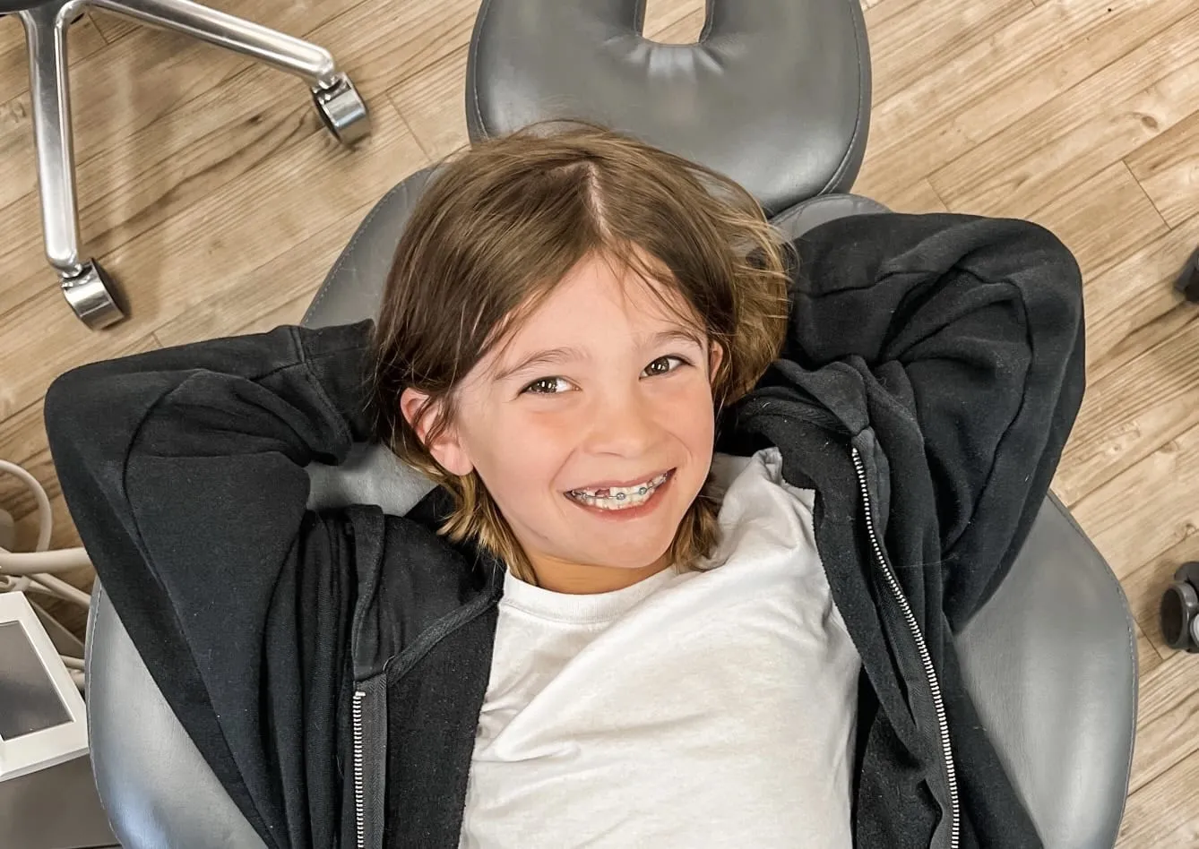 Young boy smiling and showing off his new braces