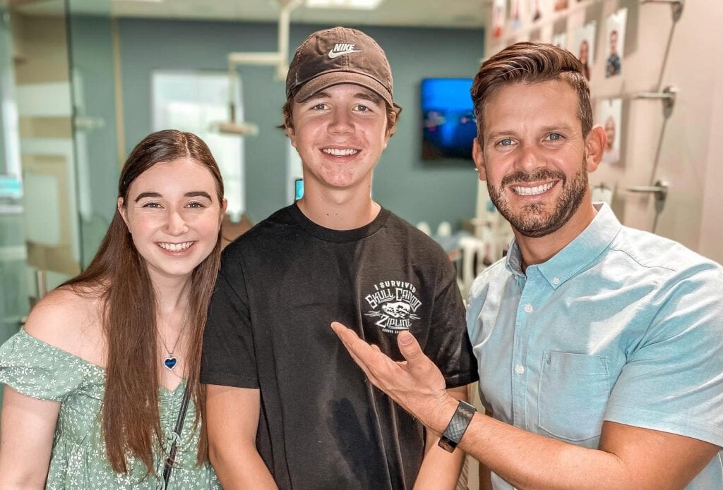 Dr. Rucker showing two teenagers wearing their new Invisalign In Murrieta, CA