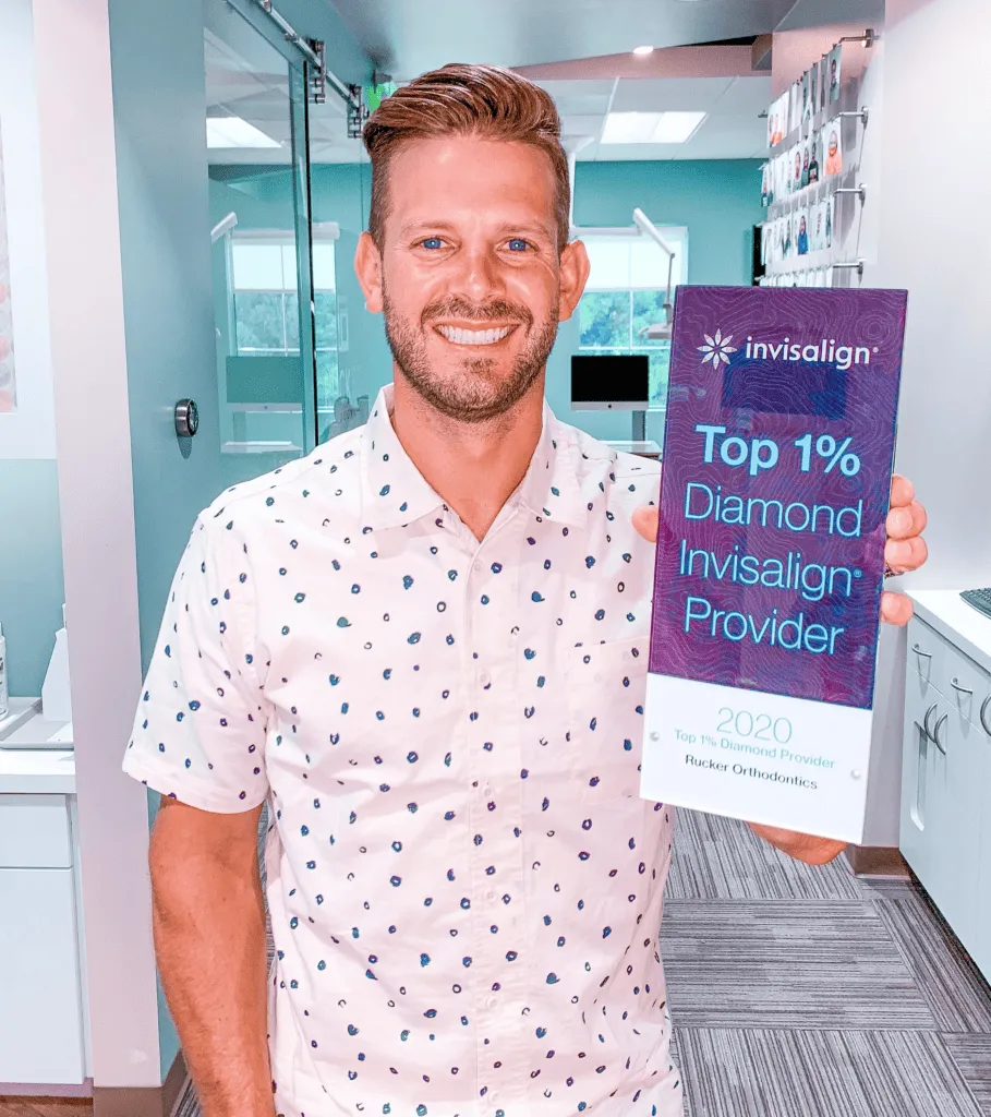 Dr. Rucker holding an Invisalign award showing Rucker Orthodontics In Murrieta, CA is a Diamond Invisalign Provider.