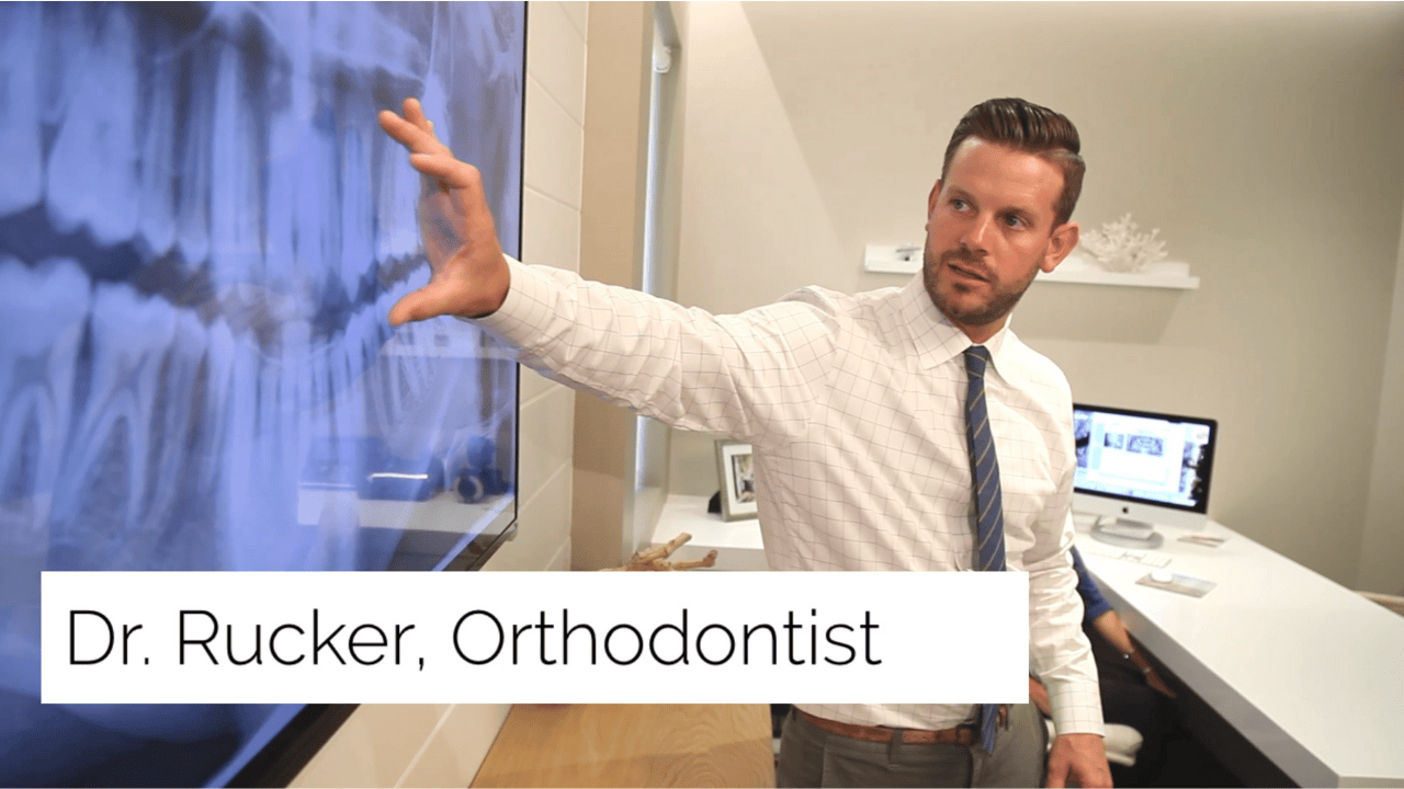 Dr. Rucker reviewing a panoramic dental X ray during an orthodontic consultation.