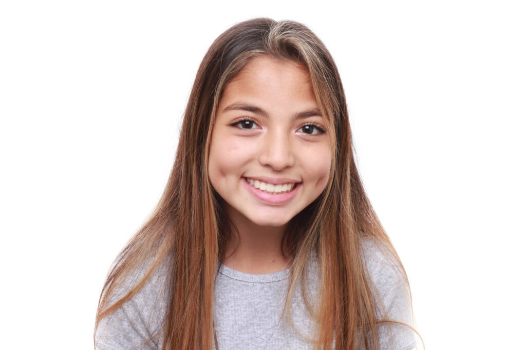 Our orthodontic team | Rucker Orthodontics A young Rucker Orthodontics patient smiling against a white background.